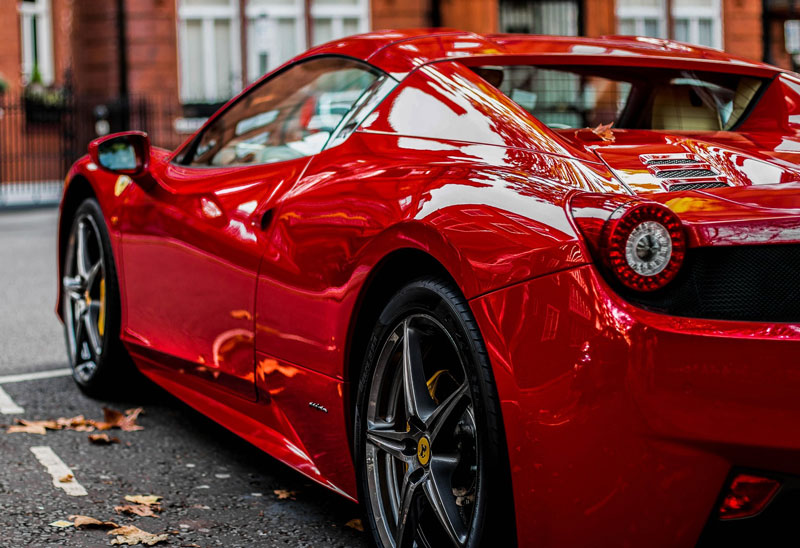 A red sports car with paint protection products applied to the exterior.