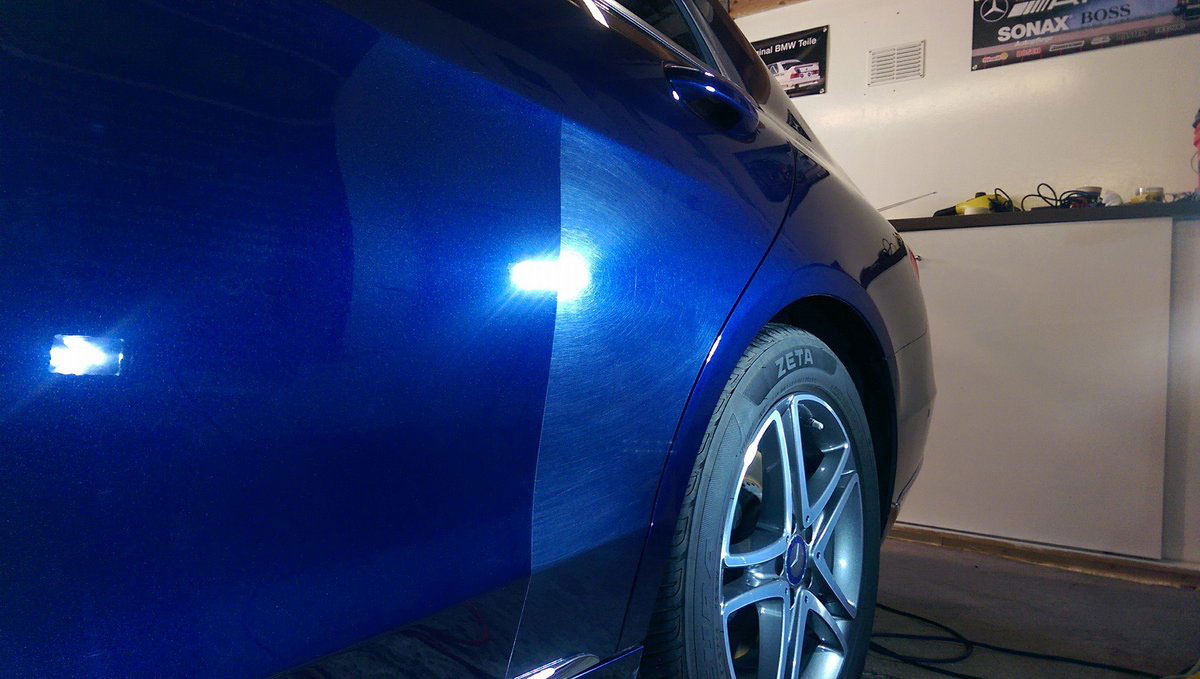A blue car with swirl marks vs repair completed with paint correction