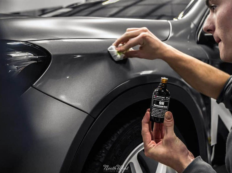 A professional ceramic coating being applied by an auto salon