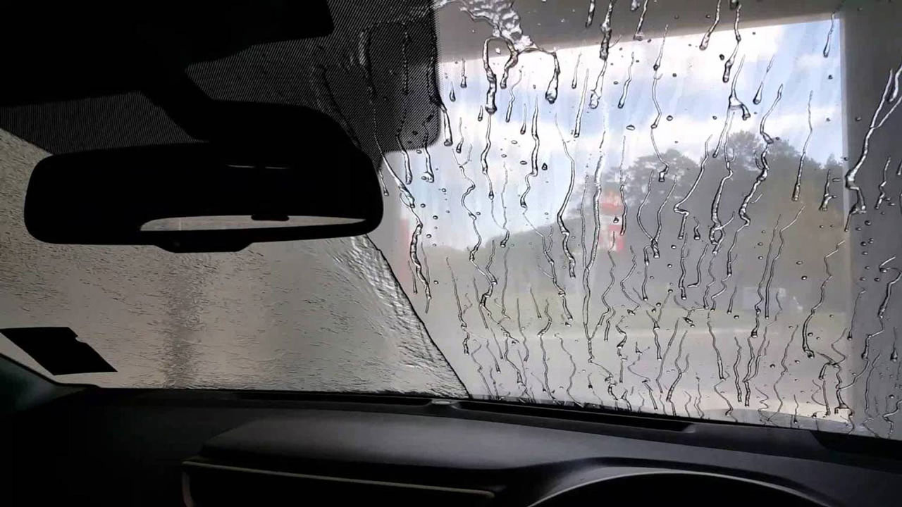 An example of a windshield with half of it covered in a ceramic coating, the other side without. 