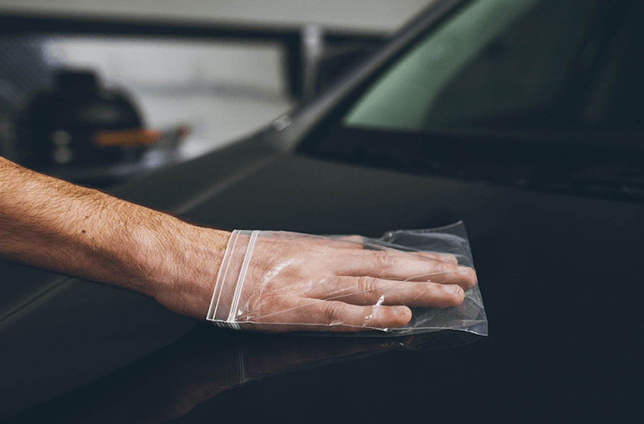 The plastic bag method of testing the car's paint surface after using a clay bar or clay mitt.