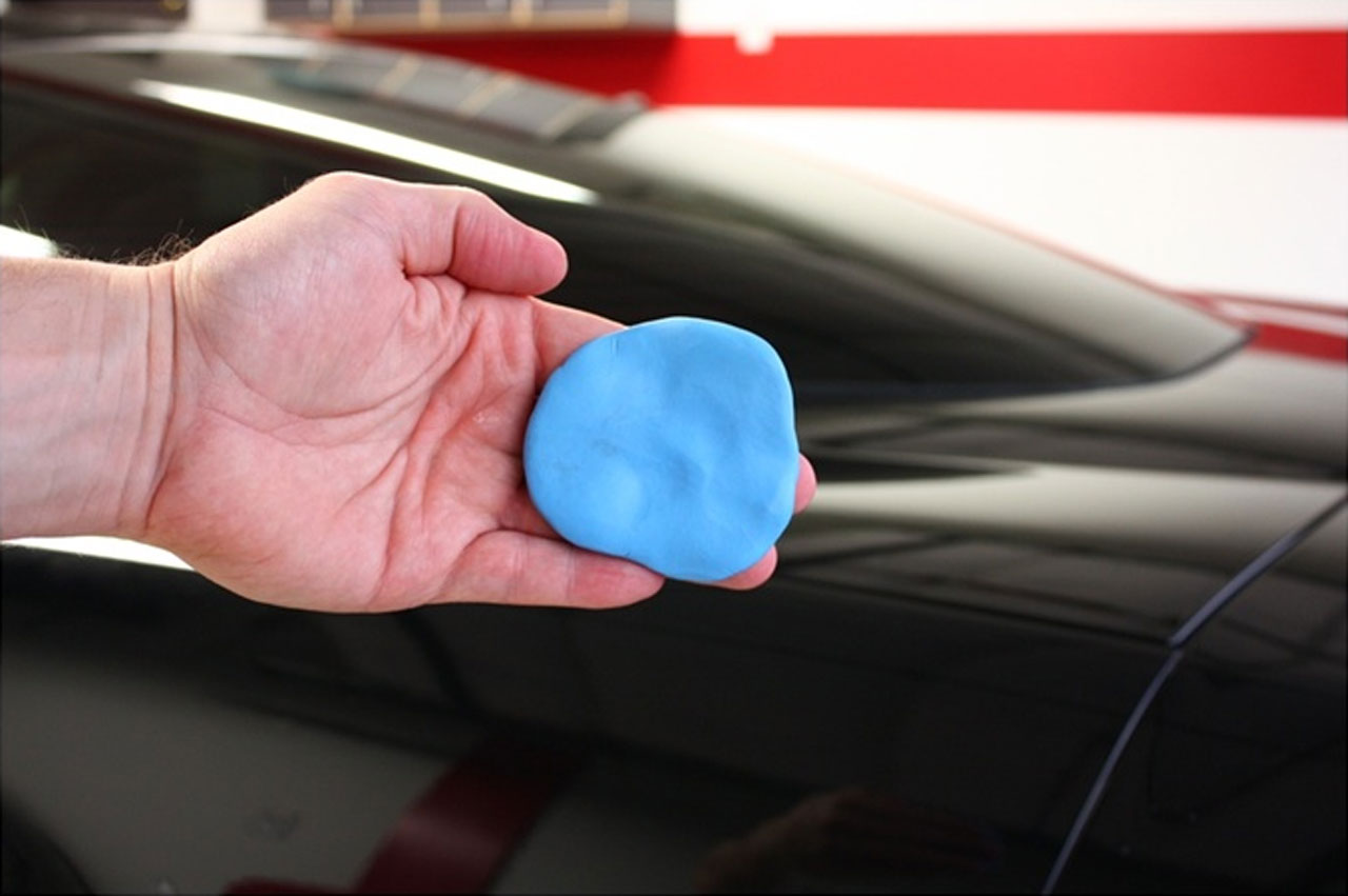 A sample of a clay bar used to remove debris from the car's paint finish.